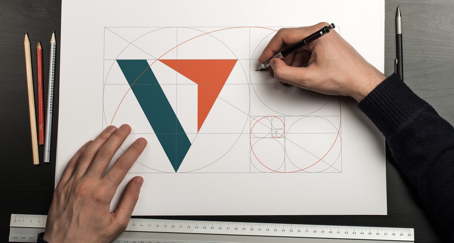 man sketching Vantage logo with golden ratio as guideline